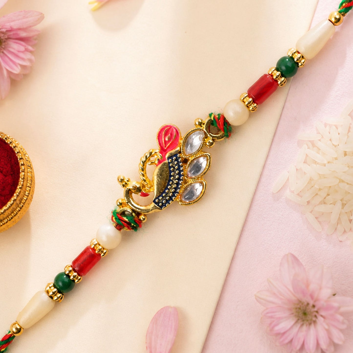 Diamond Shaped Kundan Pendant Rakhi with Peacock Feather Accent