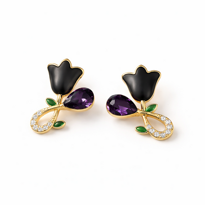 Elegant black floral stud earrings shown from top angle with crystal