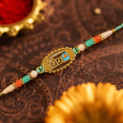 Shiv Script Pendant Rakhi with Teal and Orange Beads