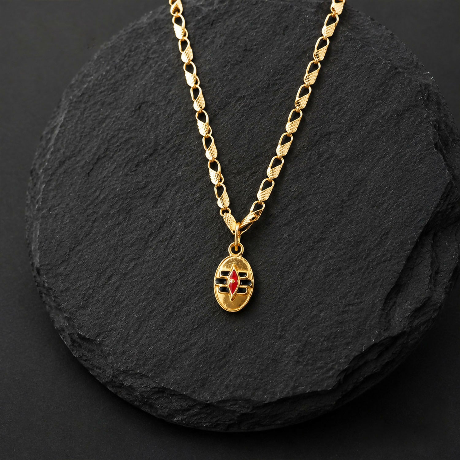 Necklace displaying gold-tone Shiva Tilak pendant and chain
