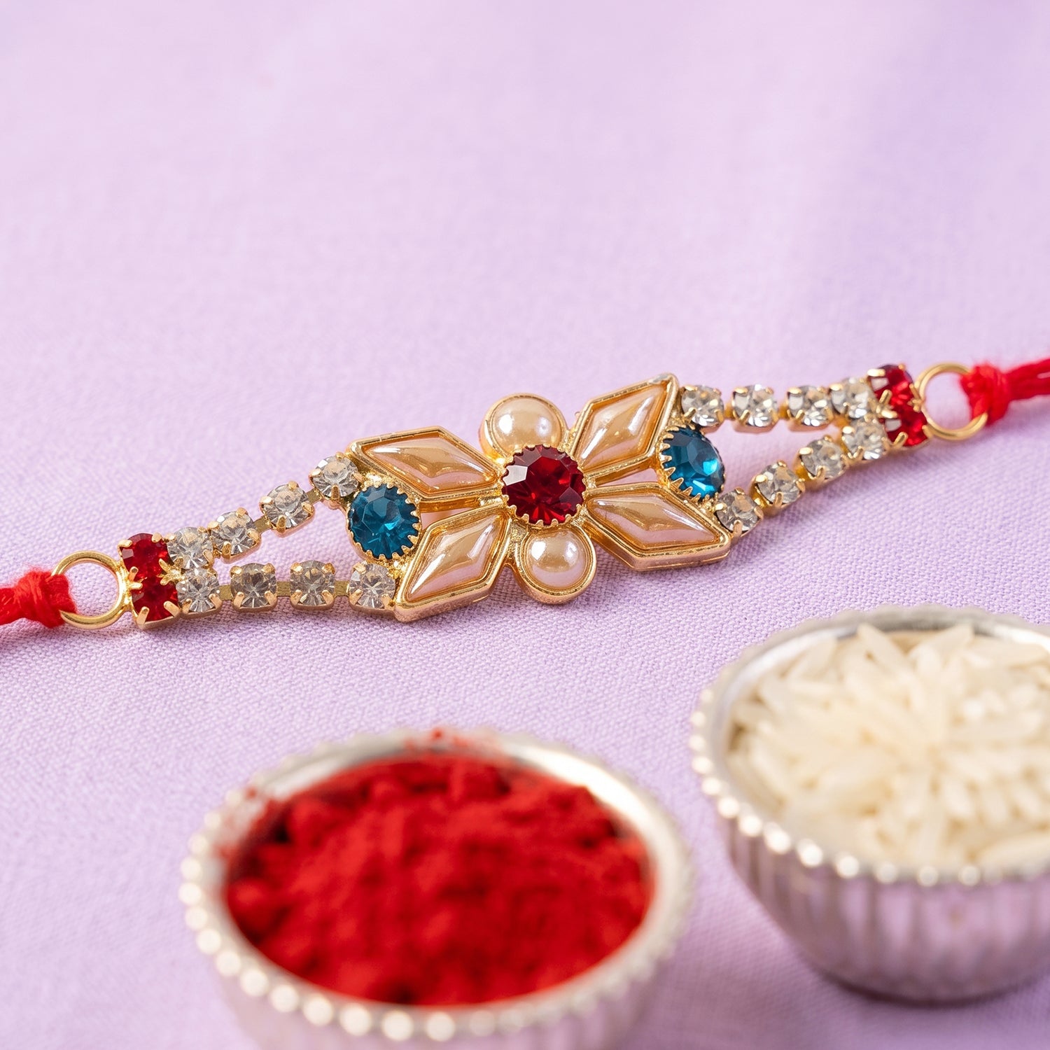 Pastel Floral Kundan Rakhi with Blue Stone and Pearl Center