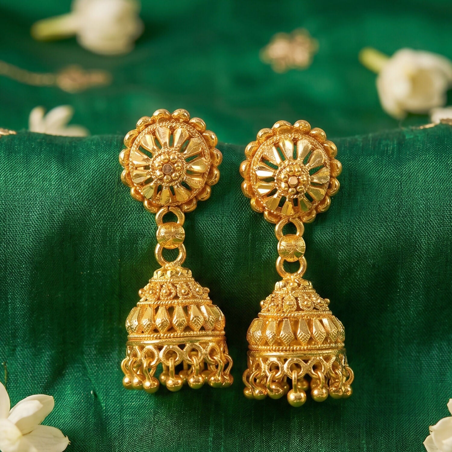 Side view of gold jhumka earrings with pearls