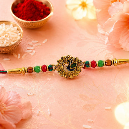 Green Peacock Enamel Rakhi with Golden Medallion, Multicolor Beads and Red Thread