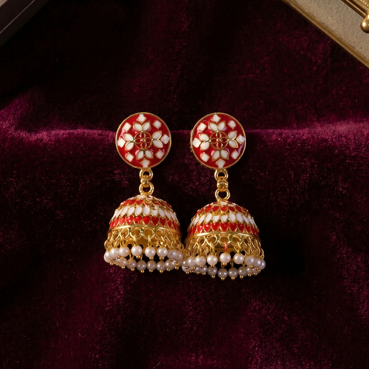 Red floral jhumka earrings with intricate floral patterns
