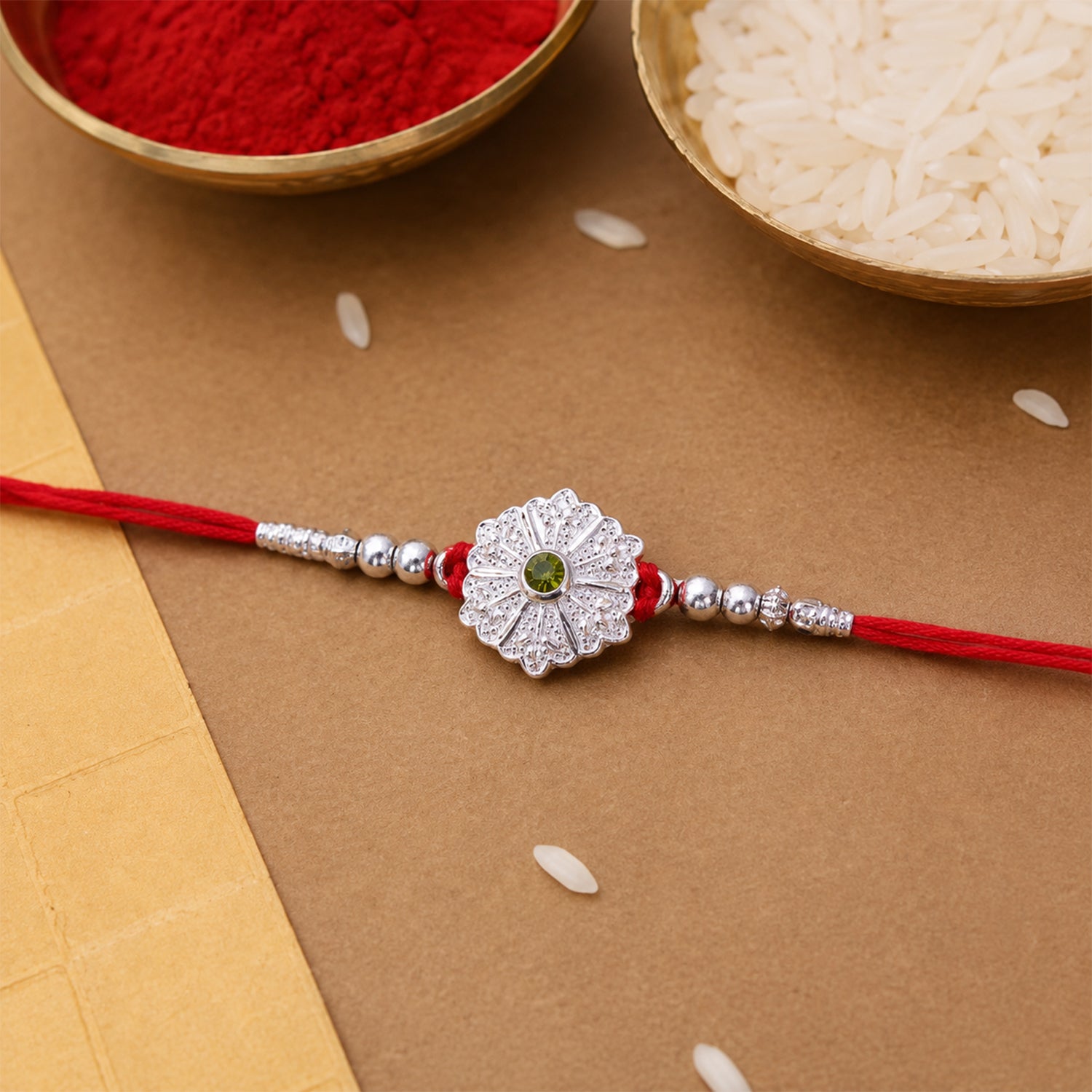 White Daisy Rakhi with Silver Beads and Soft Green Stone Center