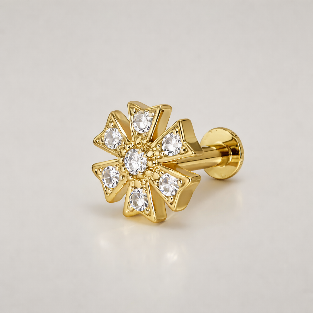 Side view of a gold plated floral nose pin stud with clear stones