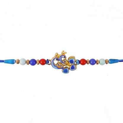 Detailed golden enamel work on Twin Peacock designer Rakhi