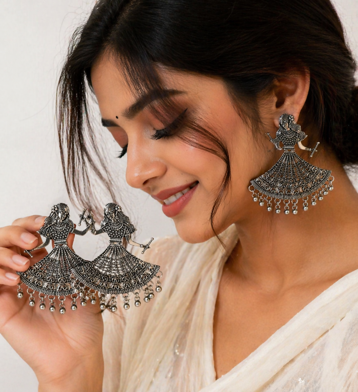 Elegant oxidized silver earrings with metallic ghungroos for festive occasions