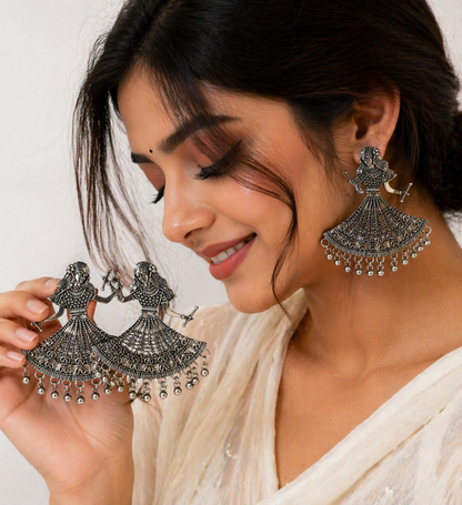 Elegant oxidized silver earrings with metallic ghungroos for festive occasions