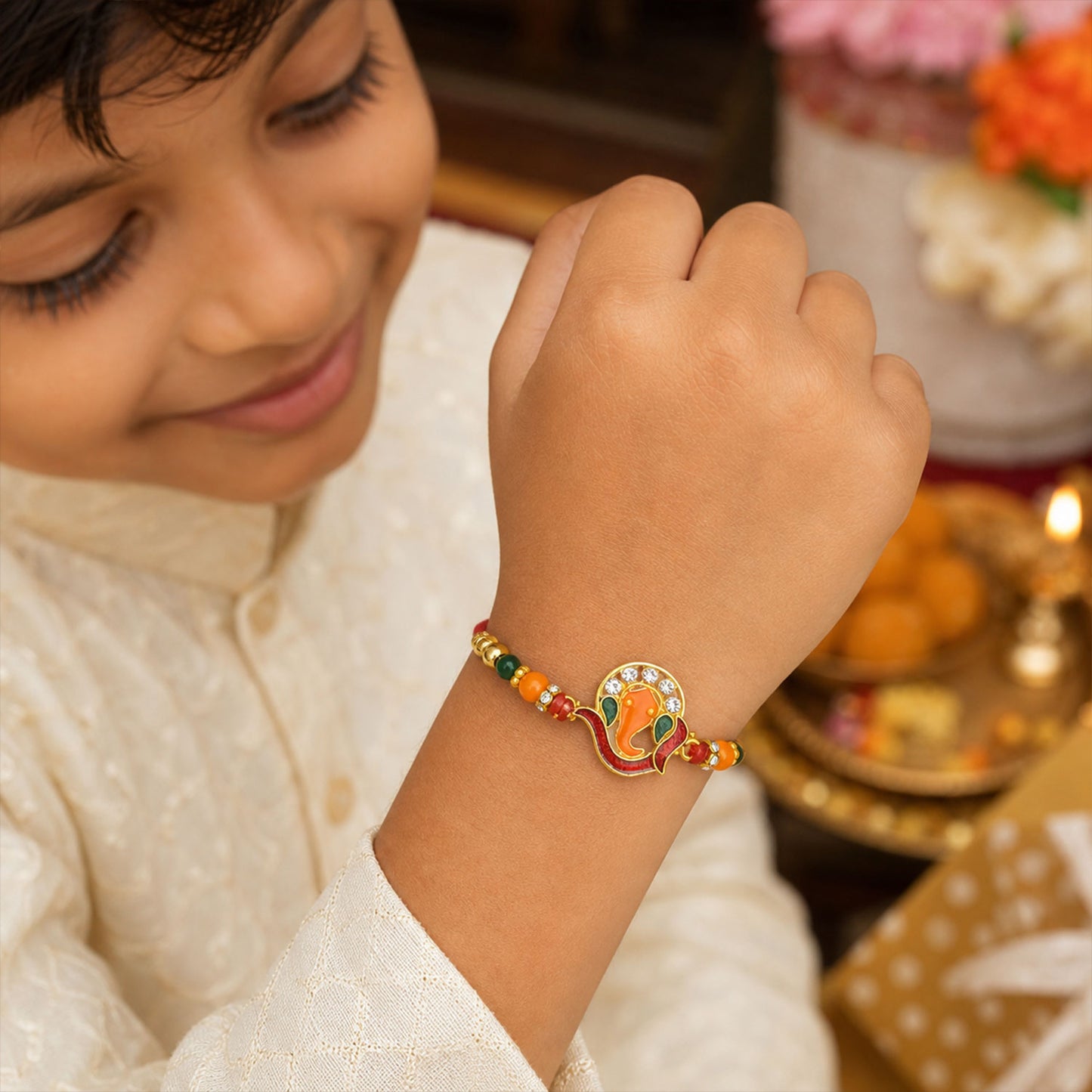 Ganesha Rakhi – Golden with Red-Green Beads & Stone Work