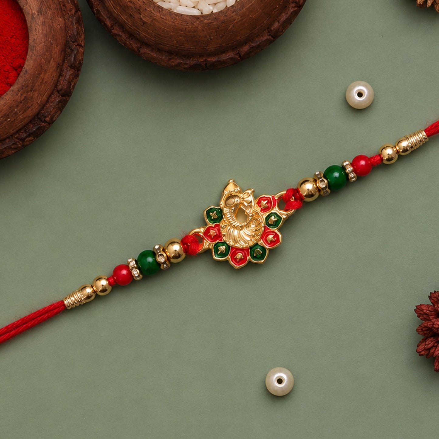 Ganesha Rakhi displayed against a festive Indian background.