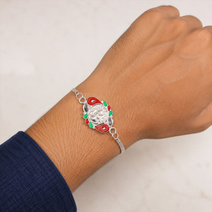 A brother's wrist adorned with the beautifully designed Ganesha Rakhi, celebrating sibling love.
