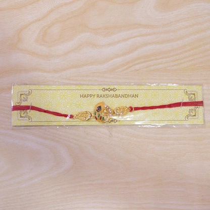 Krishna Flute Rakhi – Golden Enamel Design for Brother's Wrist