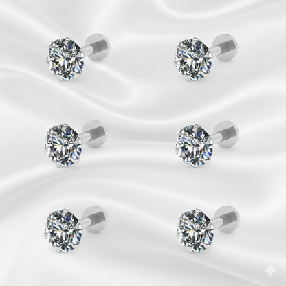 Multiple pairs of silver plated round CZ stud earrings arranged on white background