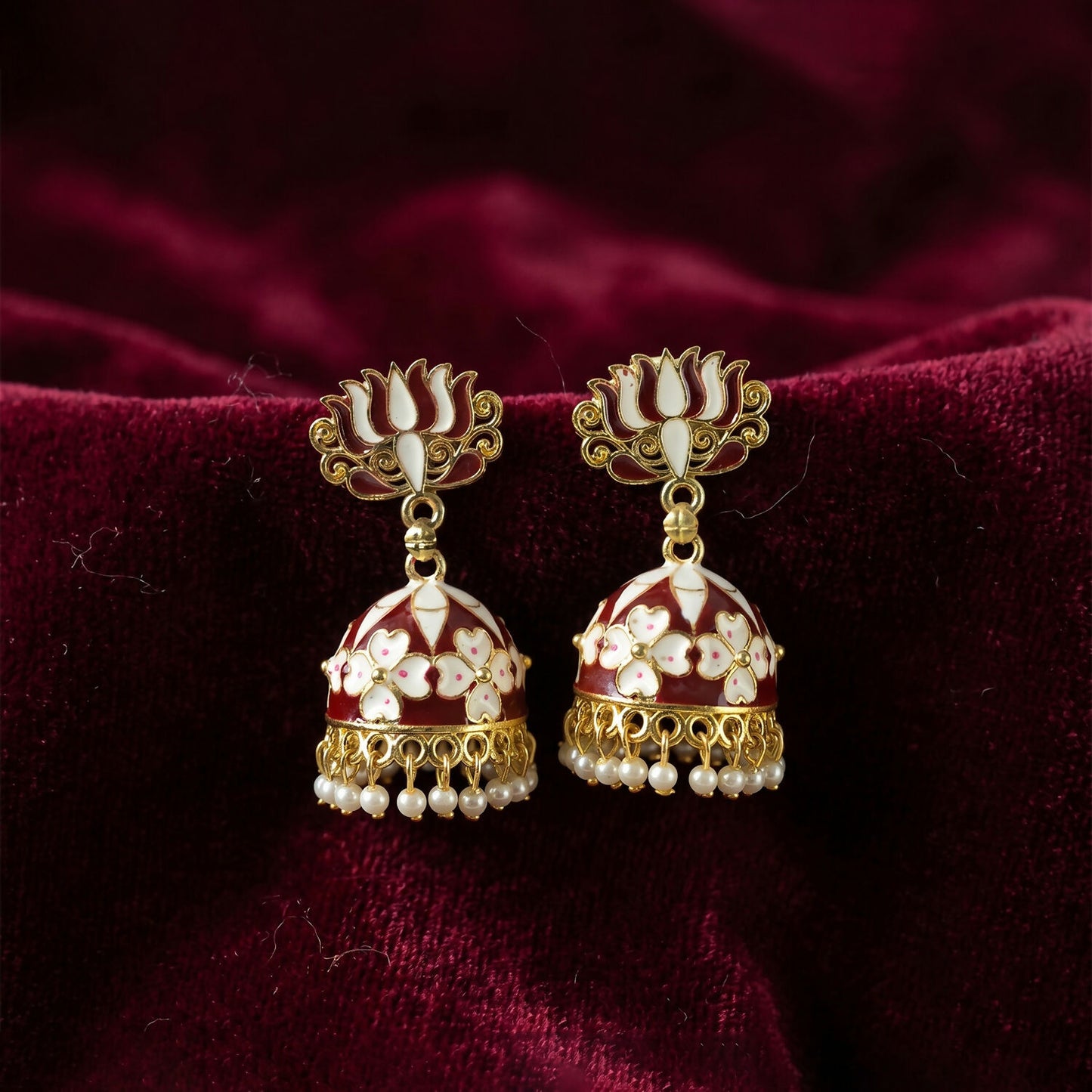 Maroon lotus jhumka earrings shown worn with ethnic attire