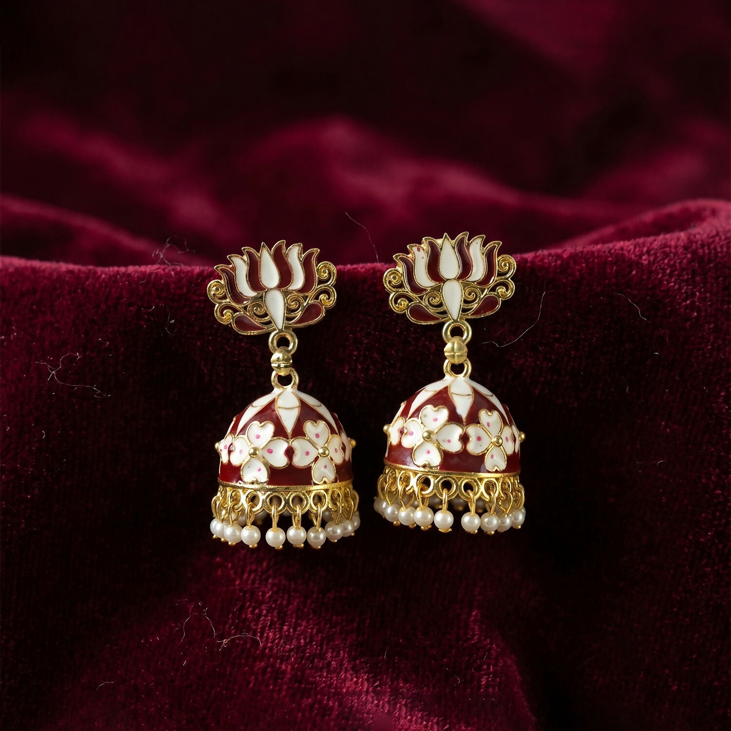 Maroon lotus jhumka earrings shown worn with ethnic attire