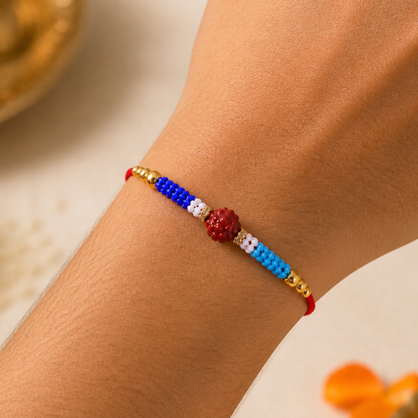 Blue Red Beaded Rakhi with Gold Accents and Classic Festive Brother Gift Appeal Ideas