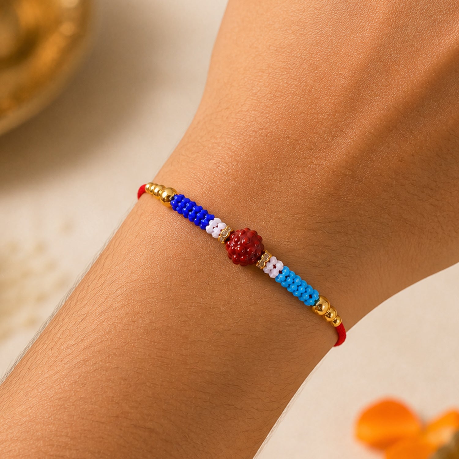 Blue Red Beaded Rakhi with Gold Accents and Classic Festive Brother Gift Appeal Ideas