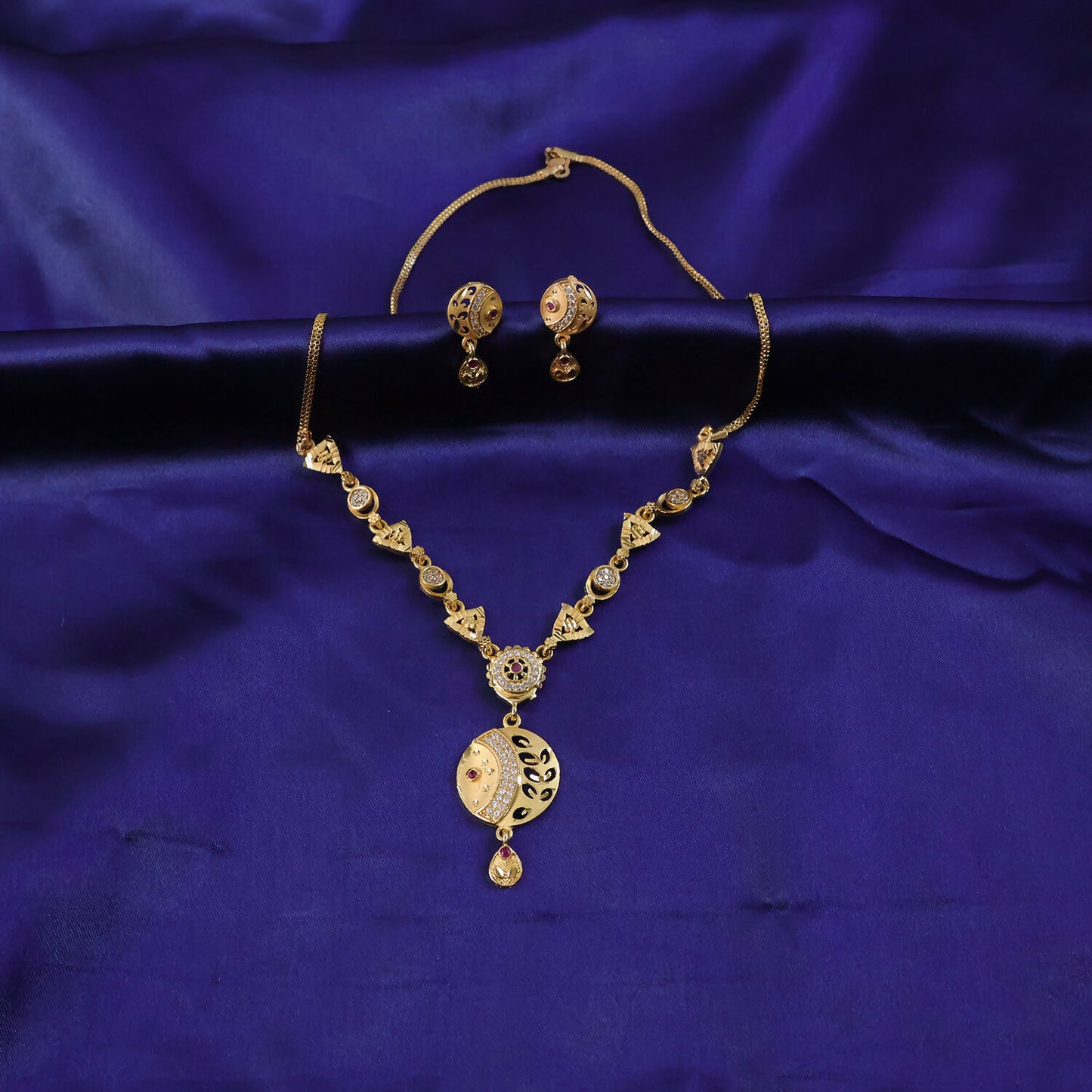 Matching earrings and necklace set in gold-tone finish for festive wear