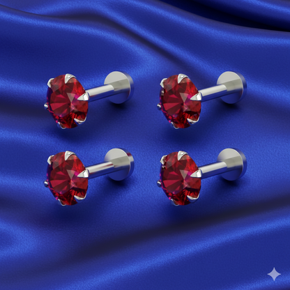 Close-up of rose gold flat-back nosepin stud featuring vibrant red cubic zirconia
