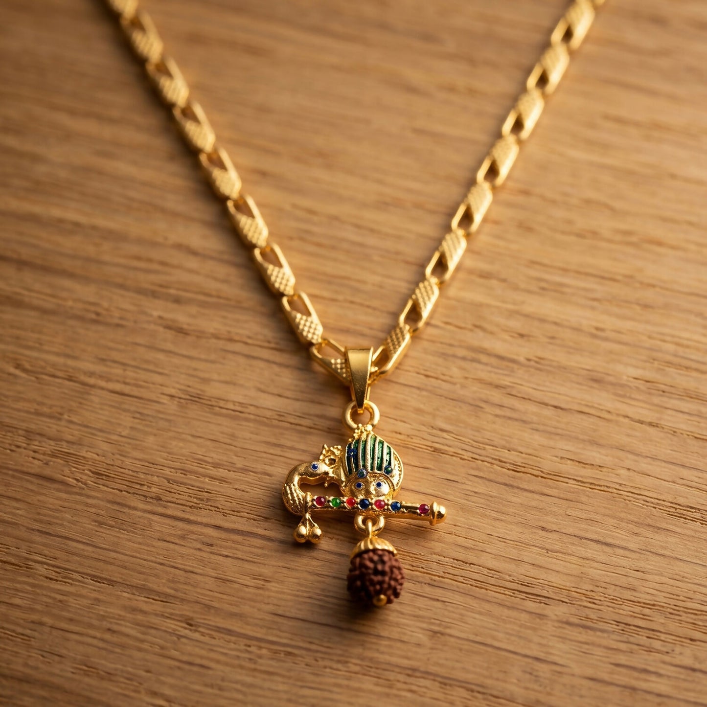 Elegant gold pendant featuring peacock feather, flute, Rudraksha bead for spiritual grace