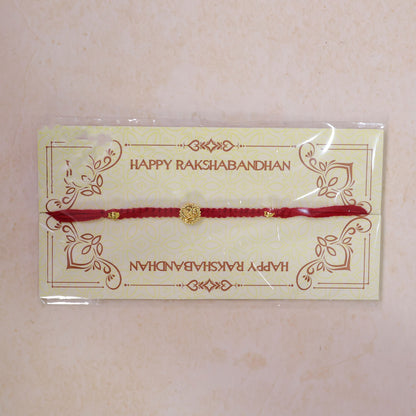 Red Thread Rakhi with an Antique Gold Om Pendant and Beaded Accents