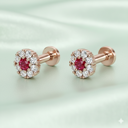 Close-up view of rose gold floral halo nose pin with bright red ruby gemstone
