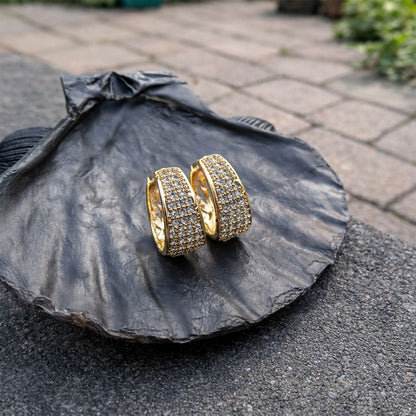 Elegant gold crystal-studded hoop earrings paired with formal wear