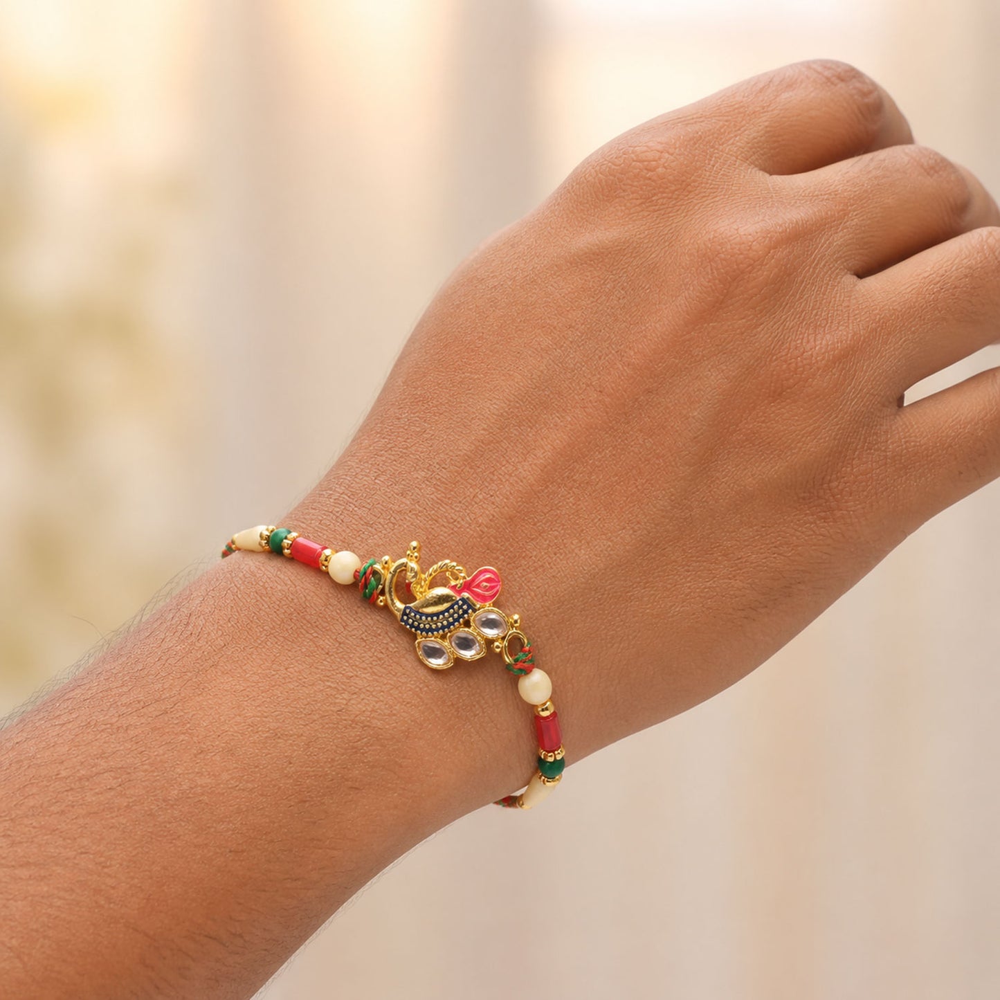 Diamond Shaped Kundan Pendant Rakhi with Peacock Feather Accent