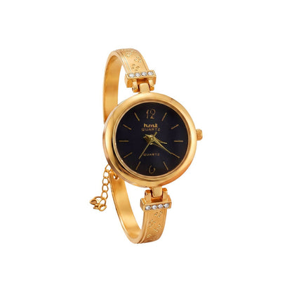 Close-up of elegant golden bracelet watch dial and strap