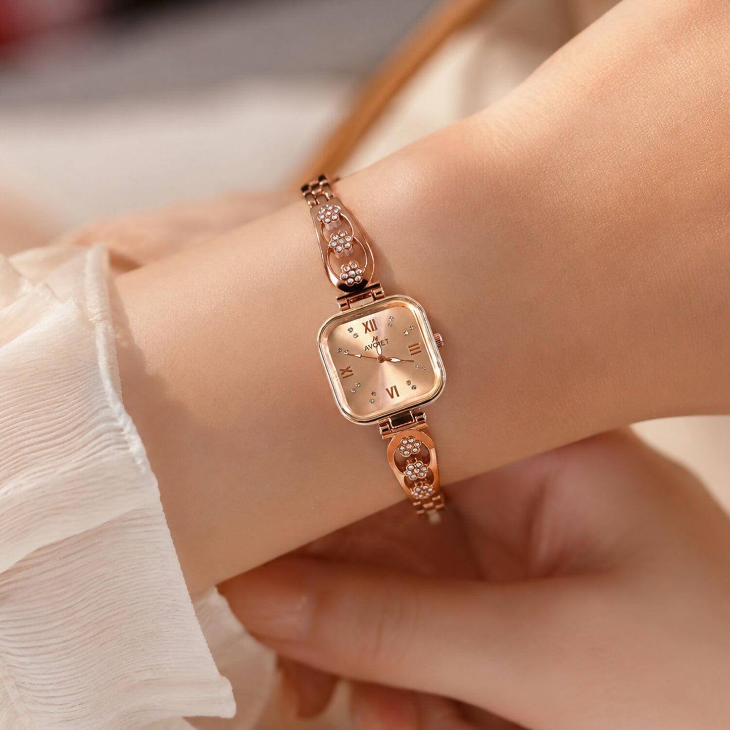 Side view of the women's rose gold watch showcasing its sleek profile and floral bracelet.