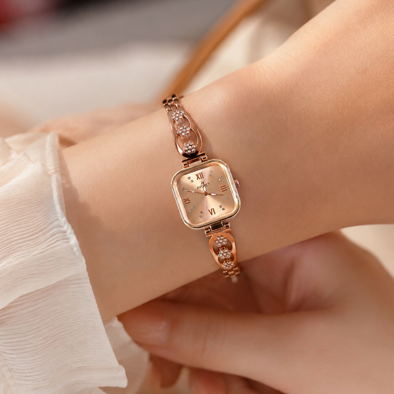 Side view of the women's rose gold watch showcasing its sleek profile and floral bracelet.