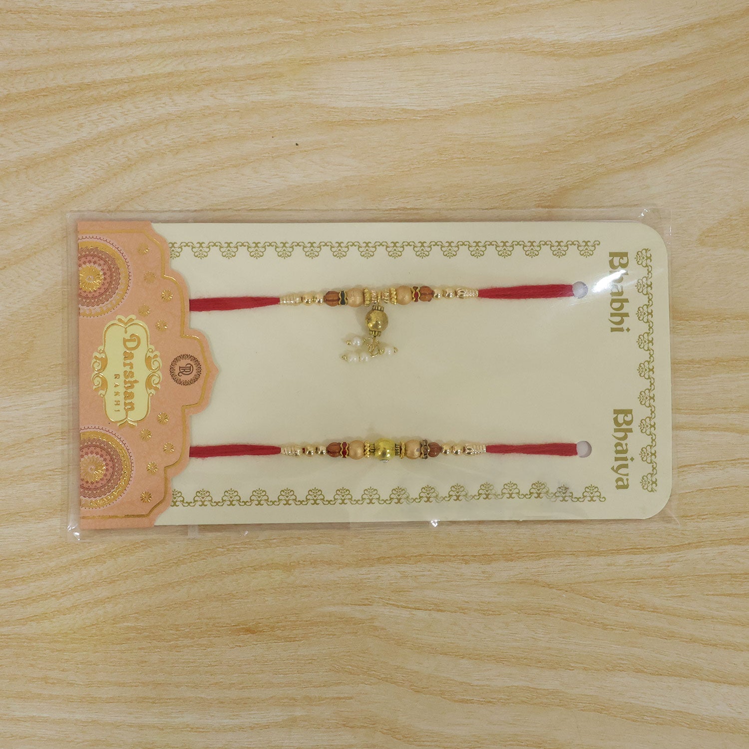 Bhai Bhabhi Kundan Rakhi Set with Red Thread, Gold Beads and Pearl Drop Accent Design