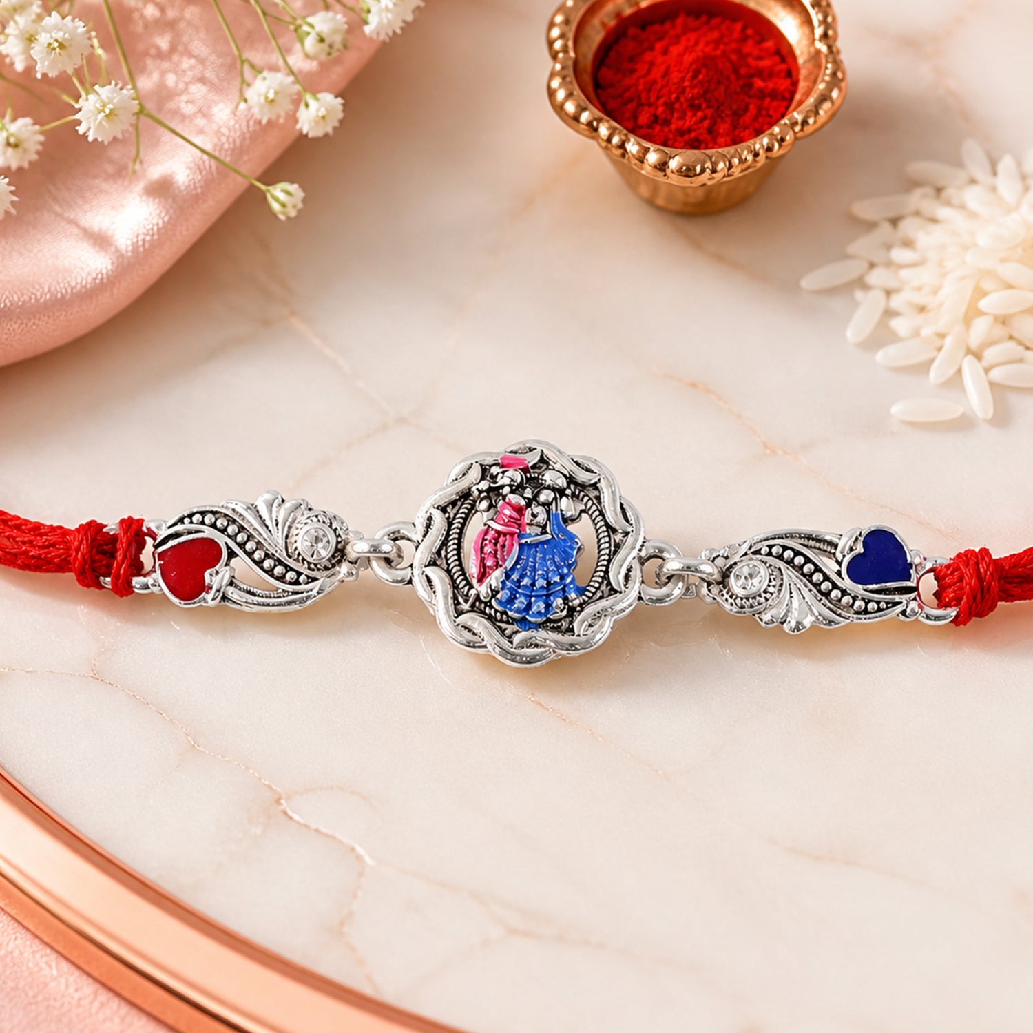 Silver-Toned Radha Krishna Rakhi with Colorful Enamel, Crystal Accents & Designer Red Thread