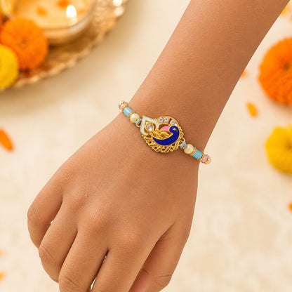 Festive Rakhi featuring Peacock Charm, blue stones and wrist style for Raksha Bandhan