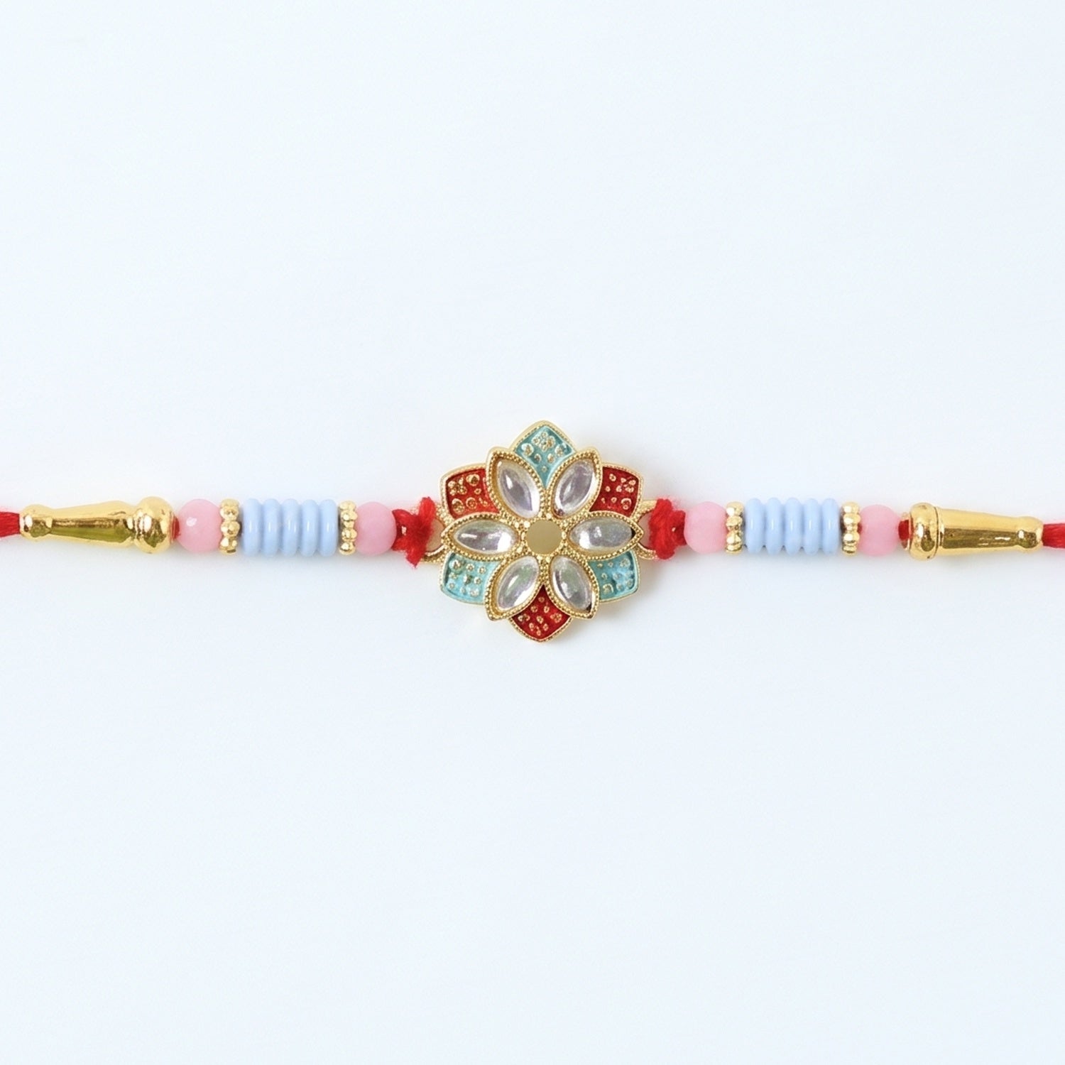 Side view of floral kundan star petal rakhi with soft tying thread