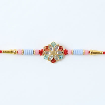Side view of floral kundan star petal rakhi with soft tying thread