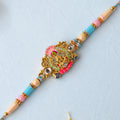 Gold Peacock Kundan Pendant Rakhi with Pastel Beads