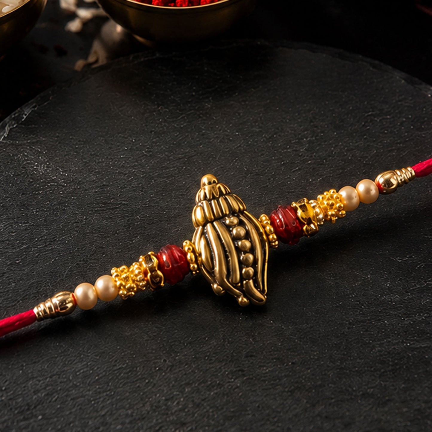 Shankh Conch Golden Devotional Rakhi with Pearl Beads, Red Accents and Antique Finish