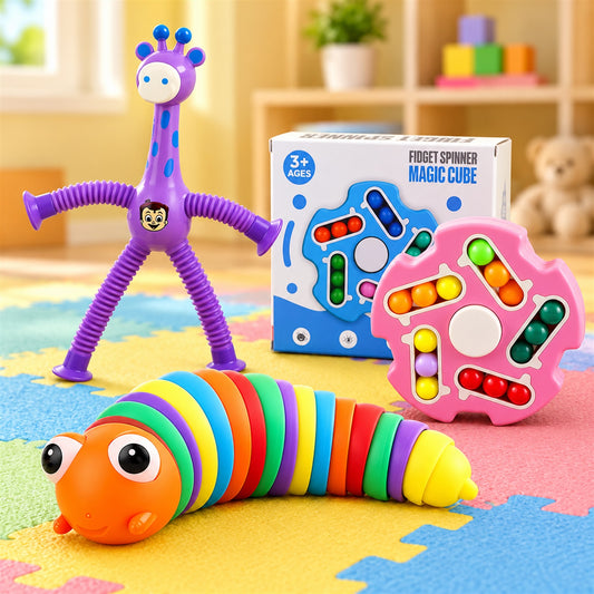 A purple giraffe toy, a rainbow worm toy, and a pink fidget spinner with colorful beads on a play mat.