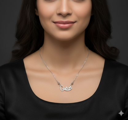 Elegant silver tone Queen pendant necklace with polished bead accents near the pendant