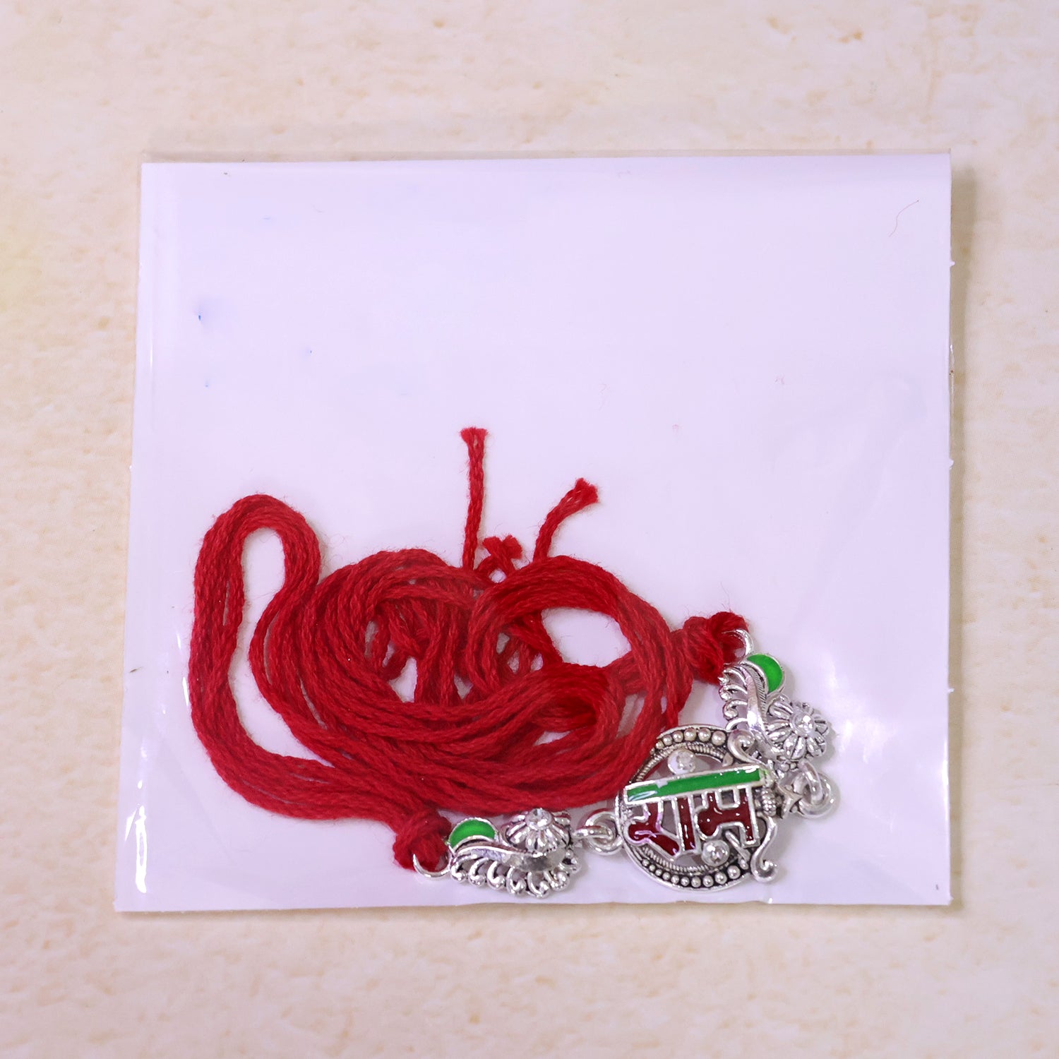 Silver-Toned Ram Rakhi with Red & Green Enamel and Crystal Accents for Brother