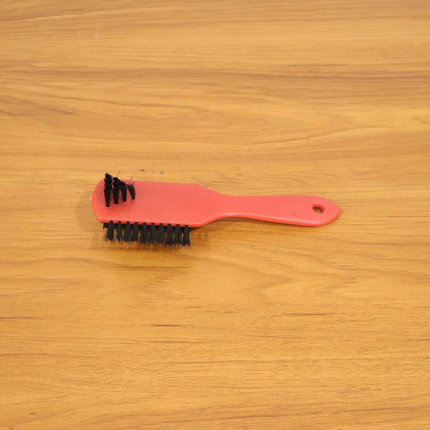 Shoe cleaning brush in use on sneakers