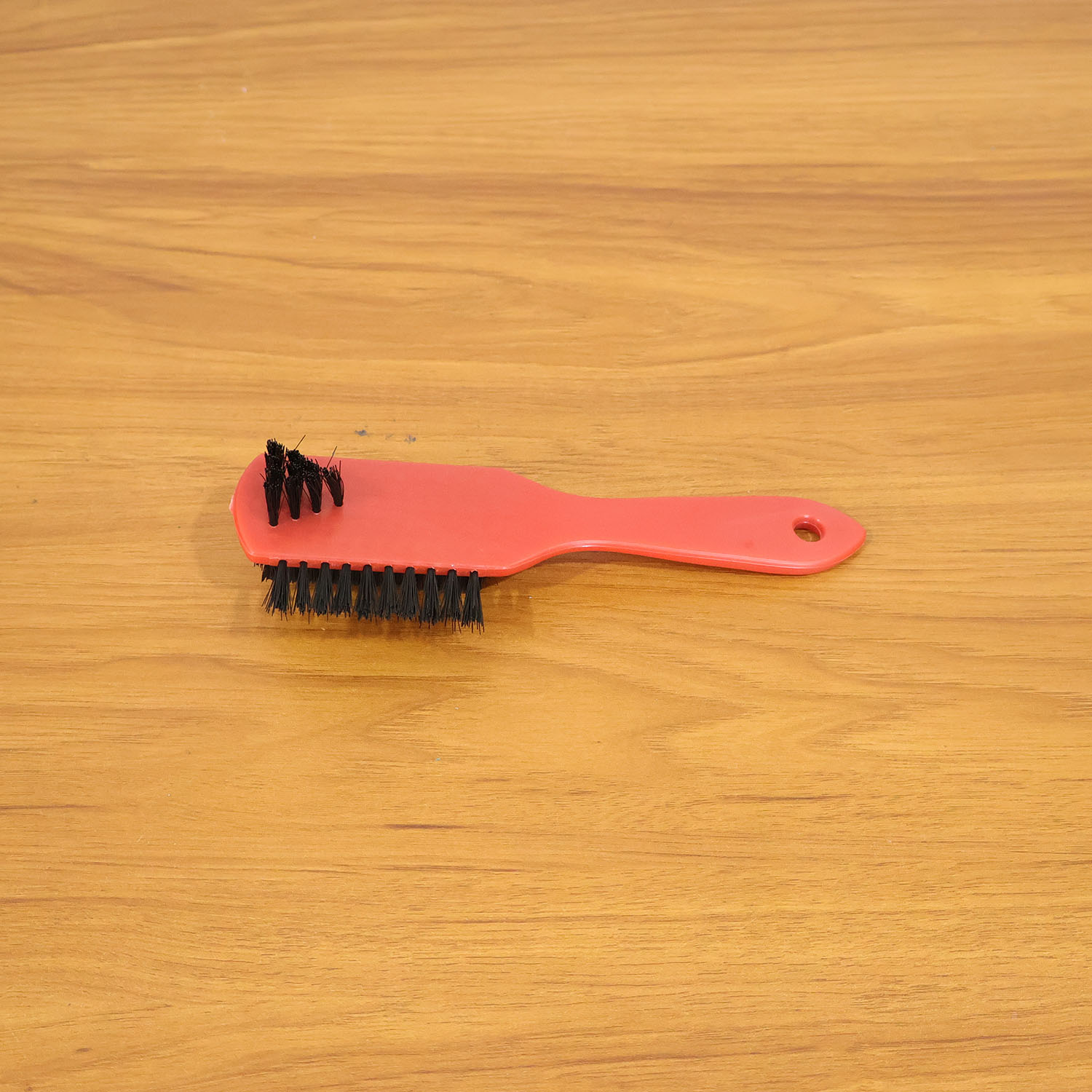 Shoe cleaning brush in use on sneakers