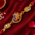 Festive Rakhi featuring Peacock Charm, pink accents and wrist style for Gift Styling