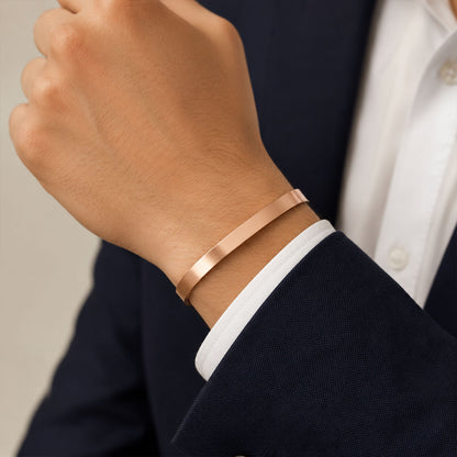 Stylish rose gold kada for men worn on a wrist.