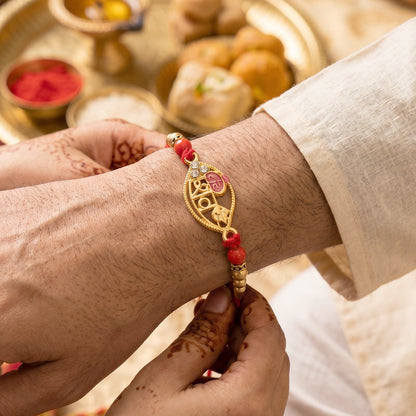 Gold Leaf Shiv Rakhi with Pearl Sides and Red Beads