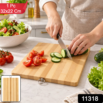 A person's hands are visible, slicing a cucumber on a bamboo cutting board, with various vegetables around.