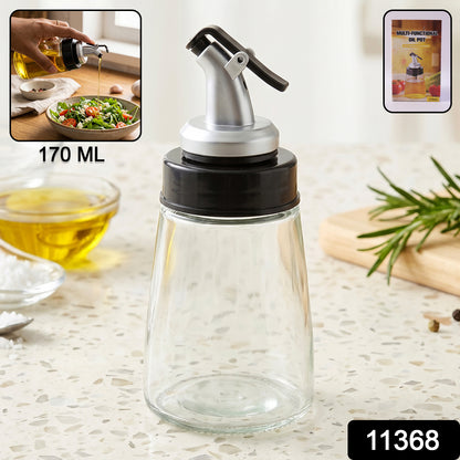 Close-up of glass oil dispenser with flip-top lid and stable base.