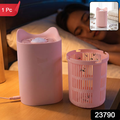 A pink cat-shaped mosquito killer lamp is shown with its collection basket, full of dead mosquitoes, on a nightstand with a